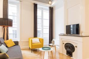 a living room with a couch and a fireplace at DIFY Lovely - Cordeliers in Lyon