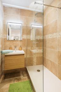 a bathroom with a shower and a sink and a mirror at DIFY Cosy - Centre Ville in Lyon