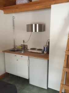 a kitchen with a sink and a counter at Stensholms Trädgård in Nässjö