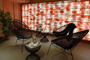 a room with chairs and a table and a window at Best Western Les Bains Hotel et SPA in Perros-Guirec