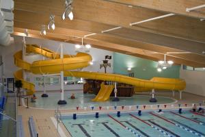 a swimming pool with a large yellow submarine in a room at iLodge 73 in Louth