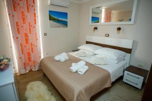 a bedroom with a bed with towels on it at Apartment Centrum in Zadar