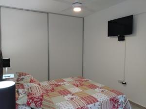 a bedroom with a bed with a quilt on it at La Recova in Alta Gracia