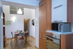 a kitchen and dining room with a table and a microwave at Casa In Piazza in Minori