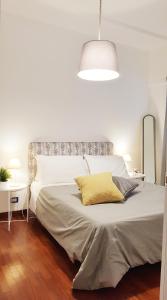 a bedroom with a large white bed with a lamp at STEFY ROME APARTMENT in Rome