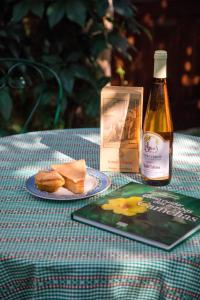 a table with a plate of food and a bottle of wine at Quinta da Picaria in Santo Tirso