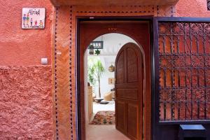 an entrance to a house with a wooden door at Riad AL RIAD in Marrakech