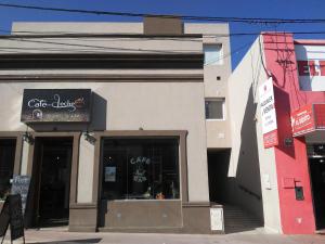 a building with a cafe label on the side of it at La Recova in Alta Gracia