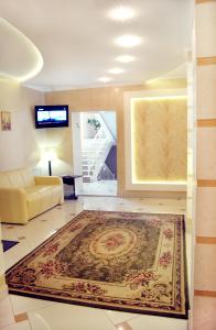 a living room with a couch and a rug on the floor at Hotel Dobrodiy in Vinnytsya