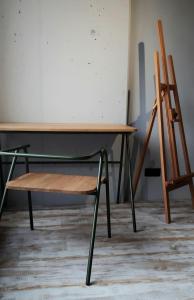 a wooden table with a chair and a desk at L1apartment in Kyiv