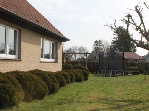 a house with a yard with a playground at Spacious Apartment in Brusow with Garden in Kröpelin