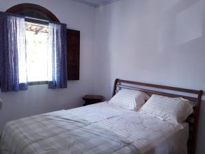 A bed or beds in a room at Pousada do Cacau