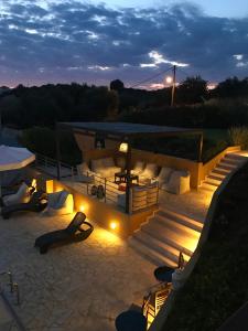 a patio with stairs and lights at night at Villa Verde in Ano Kalo Nero