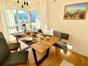 a dining room with a wooden table and chairs at FeWo Königsseer Ache in Berchtesgaden