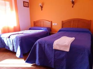 Postel nebo postele na pokoji v ubytování Hostal Río Mundo