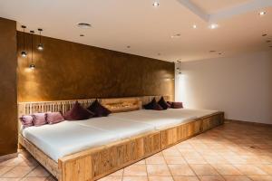 a large wooden bed in a room at Hotel Bergjuwel in Neustift im Stubaital