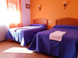 Postel nebo postele na pokoji v ubytování Hostal Río Mundo