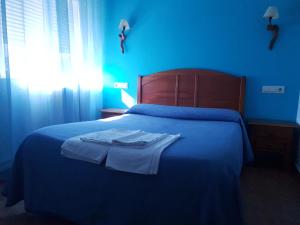 Postel nebo postele na pokoji v ubytování Hostal Río Mundo