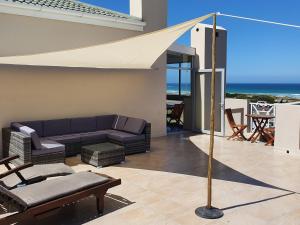 a living room with a couch and an umbrella at Big Bay Penthouse in Big Bay
