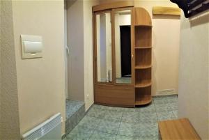a hallway with a wooden cabinet in a room at Apartaments near Švyturio arena in Klaipėda