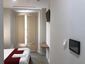 Posteľ alebo postele v izbe v ubytovaní Pinar Malaga Rooms