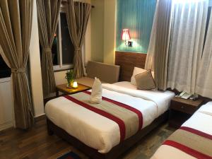 En eller flere senger på et rom på Hotel Guru