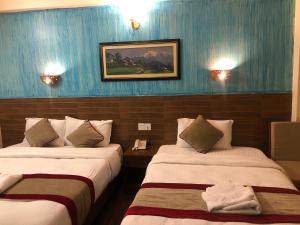 En eller flere senger på et rom på Hotel Guru