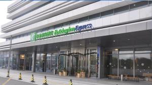 a building with a sign on the side of it at Holiday Inn Express - Suzhou Industrial Park by IHG in Suzhou