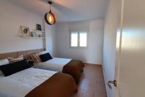 a bedroom with two beds and a window at Dúplex Águeda Altaona Golf in Murcia +66 photos