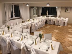 a room full of tables and chairs with white table settings at Dom św. Józefa in Szczecin