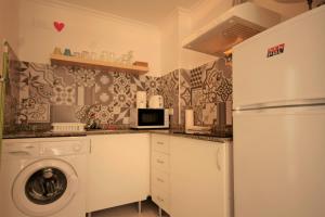 a kitchen with a washing machine and a refrigerator at Apartment Sol de Santa Pola in Santa Pola