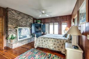 a bedroom with a bed and a brick wall at 101 Dune Lane in Hilton Head Island