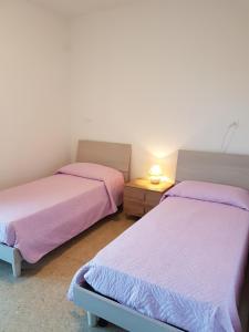 Postel nebo postele na pokoji v ubytování Casa Adua appartamento