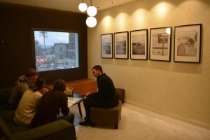 a group of people sitting around a table in a restaurant at MOUNT41 Hostel in Jericho