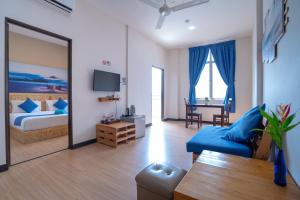 a bedroom with a bed and a living room at Paretto Seaview Hotel in Pantai Cenang +37 photos