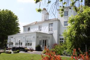 an exterior view of a white house at Fishmore Hall Hotel and Boutique Spa in Ludlow
