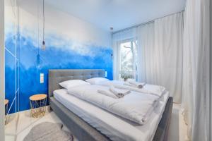 Кровать или кровати в номере Apartamenty Sun & Snow Riverfront Gdańsk