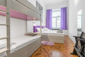a bedroom with two bunk beds and purple curtains at Munda house Big design family friendly 4BR apt in Ljubljana