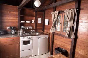 a kitchen with a stove and a sink at Miette Hot Springs Bungalows in Jasper