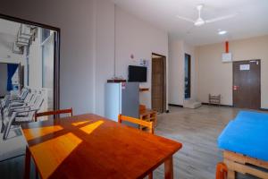 a kitchen and dining room with a table and a refrigerator at Paretto Seaview Hotel in Pantai Cenang