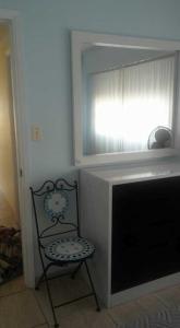 a chair sitting next to a television in a room at Club del Mar in Punta del Este