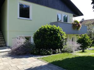 a house with some bushes in front of it at Apartma JERMAN - Cerknica in Cerknica