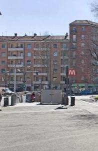 an empty parking lot in front of a large building at Metro Station Mini Van CAPSULA House in Turin