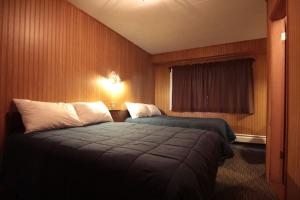 a hotel room with two beds and a window at Miette Hot Springs Bungalows in Jasper
