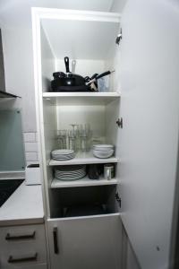 a kitchen pantry with plates and dishes in it at No 5 New Inn Apartments in Newark upon Trent +27 photos