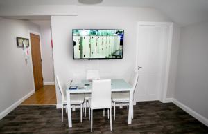 a dining room with a table and white chairs at No 5 New Inn Apartments in Newark upon Trent