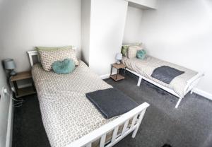 a bedroom with two beds in a room at No 5 New Inn Apartments in Newark upon Trent