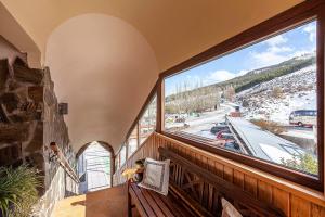 a balcony with a large window with a view of a snowy street at Hotel Sulayr in Sierra Nevada