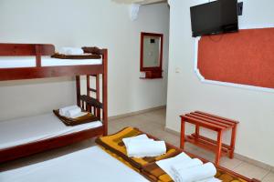 a room with two bunk beds and a flat screen tv at Glaros in Paralia Katerinis