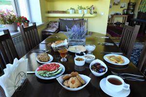 a table with plates of food on top of it at Jamilya B&B Guest House in Karakol